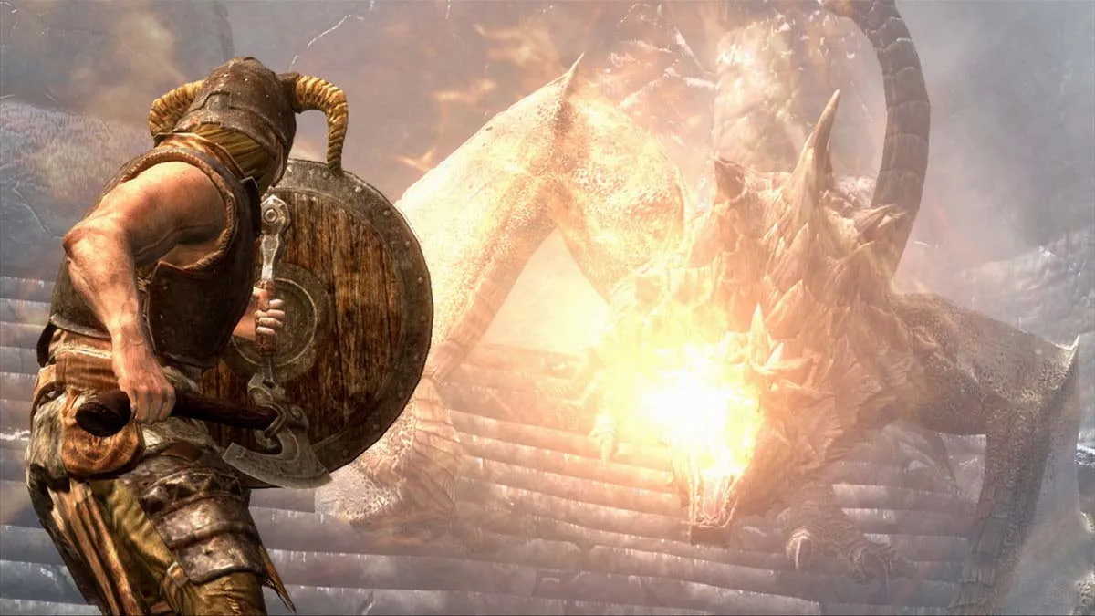 the dragonborn braces behind their shield against a dragon breathing fire