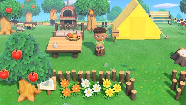 Sitting by a yellow tent and table in Animal Crossing New Horizons.