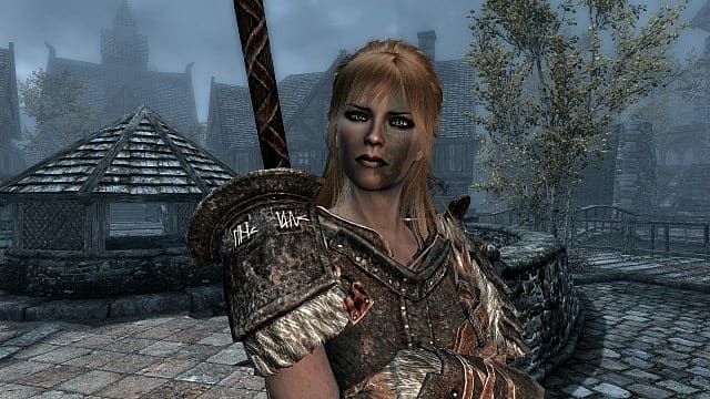 A blonde haired female warrior with her arms crossed.